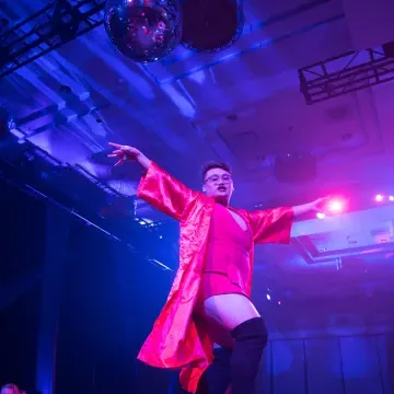 A performer on stage with fancy pink costume at the Fire ball, 澳门葡京网赌送彩金 drag ball extravaganza event